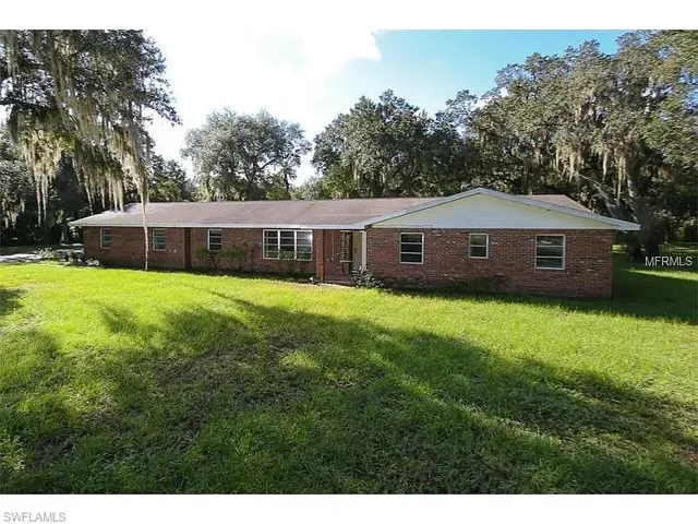 View of front of house featuring a front yard and brick siding