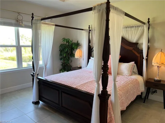 Spacious Master Bedroom with large window with privacy window treatment.