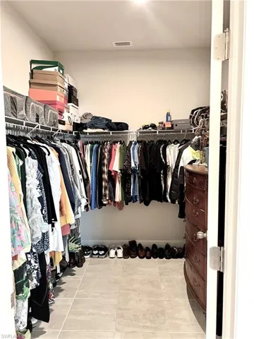 Walk in closet featuring tile patterned floors