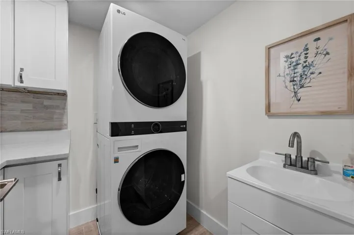 Full size in unit Laundry with Cabinets and sink.