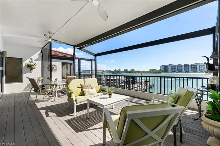 Wooden deck with a ceiling fan, an outdoor living space, a water view, and outdoor dining space