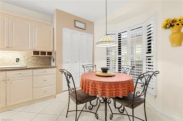 Dining space with light tile patterned floors