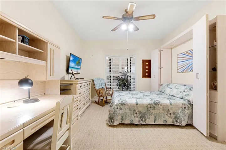 Bedroom featuring light carpet and a ceiling fan