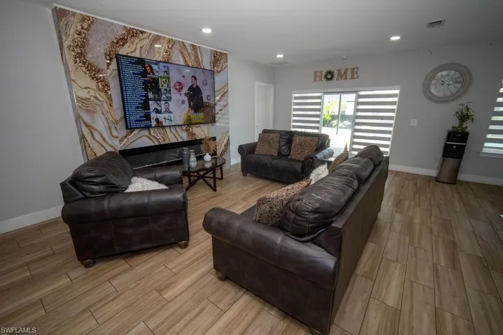 Living room with wood finish floors and recessed lighting