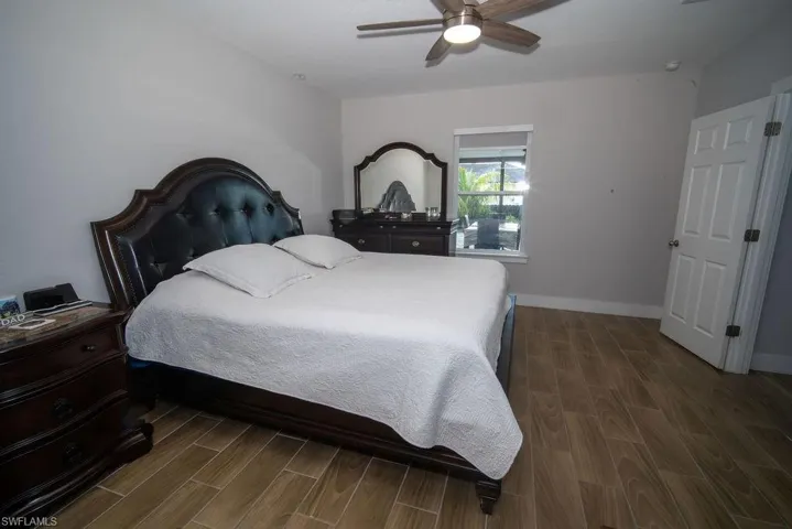 Bedroom with wood finish floors and a ceiling fan