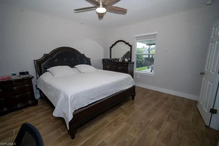 Bedroom featuring wood tiled floors and a ceiling fan
