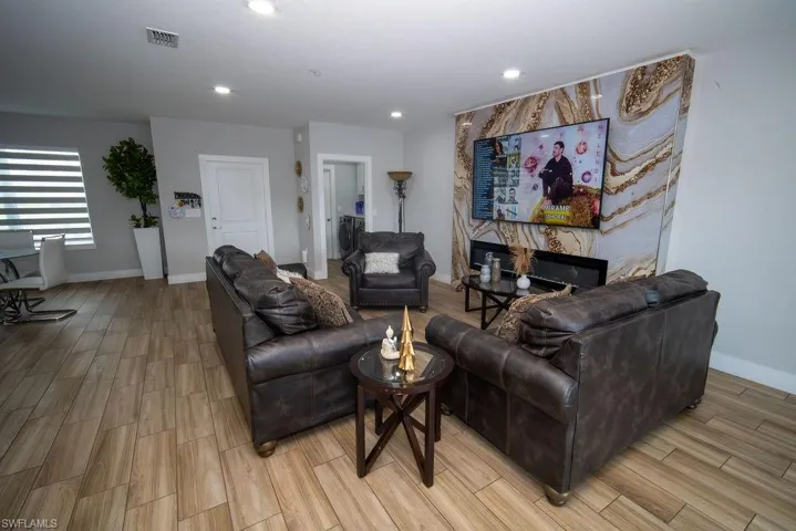Living room with wood finish floors and recessed lighting