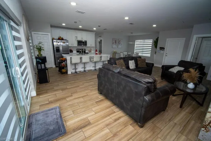 Living area with wood tiled floors and recessed lighting