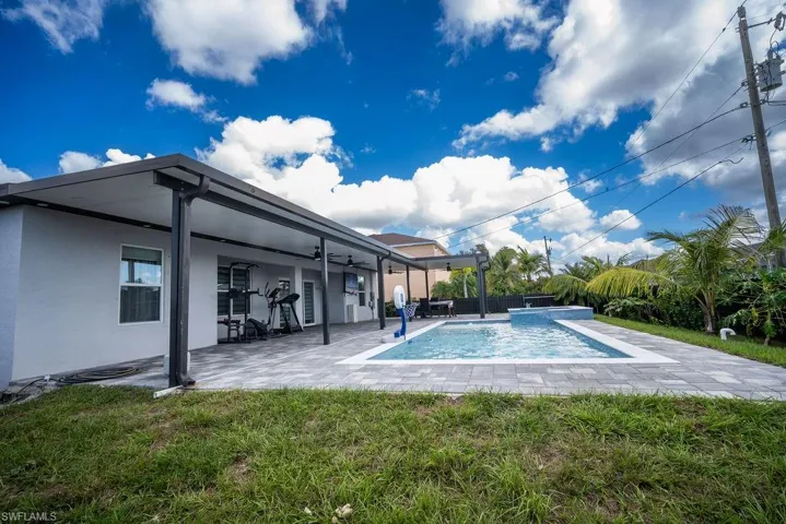 Swimming pool featuring a patio area, ceiling fan, and a fenced backyard