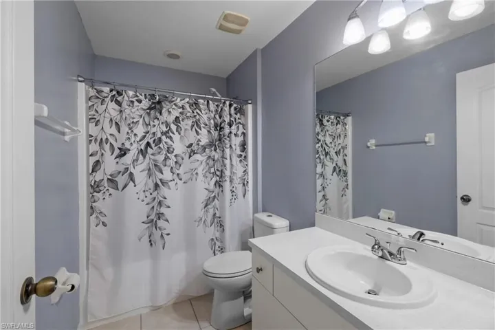 Bathroom featuring vanity with extensive cabinet space