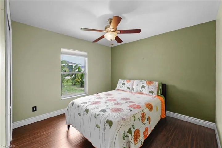 Bedroom featuring ceiling fan and hardwood / wood-style floors