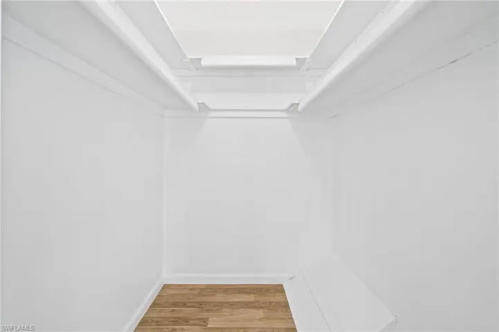 Spacious closet with wood-style flooring