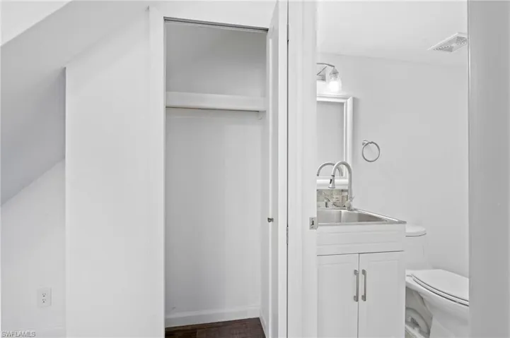 Bathroom featuring vanity, LVP wood-style floors, and toilet. First Floor Bathroom