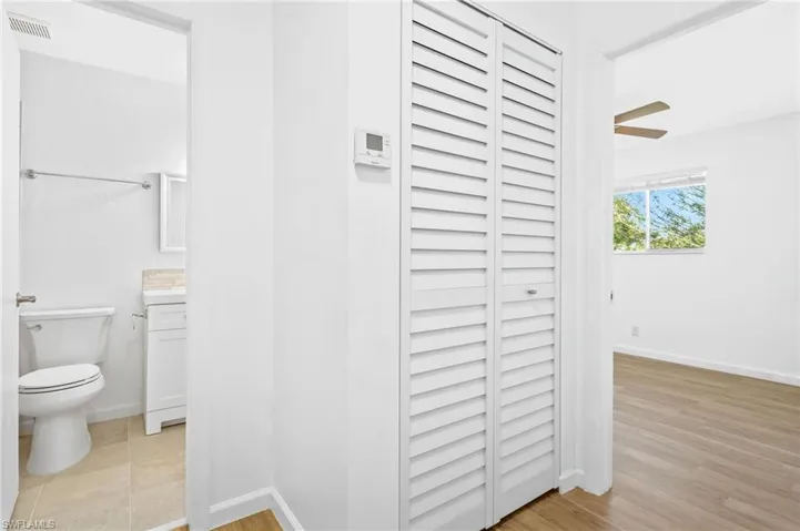 Bathroom featuring LVP wood-style floors, vanity, and toilet