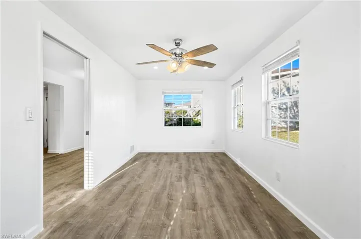 Empty room featuring ceiling fan and LVP wood-style floors, Extra Square footage