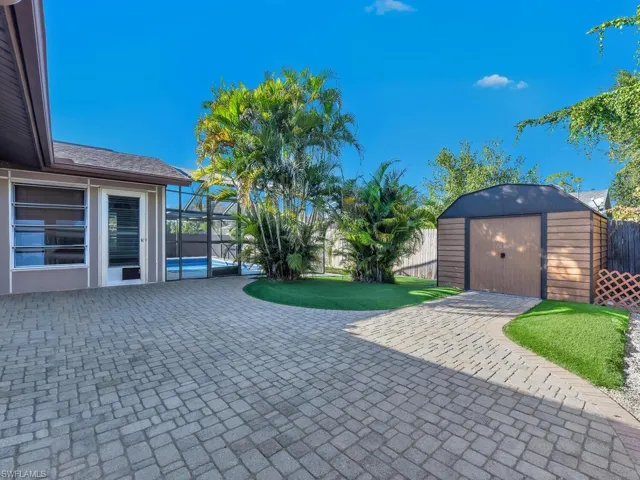 Paved Lanai area with a shed