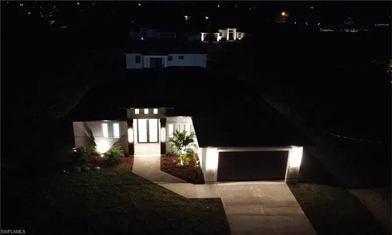 View of front of property with a garage and driveway