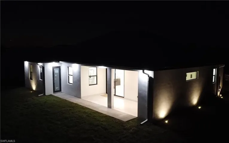 Property exterior at night with stucco siding