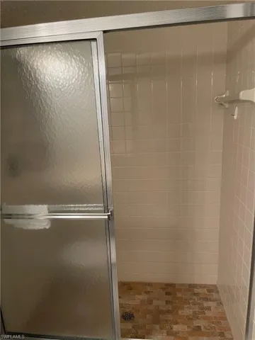 Full bathroom featuring a stall shower