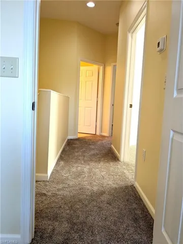Hall featuring carpet flooring and recessed lighting