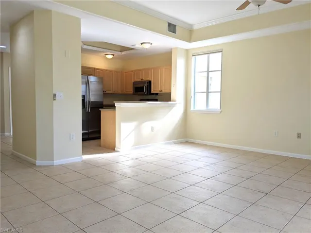 Kitchen with stainless steel appliances, ornamental molding, ceiling fan, a peninsula, and open floor plan