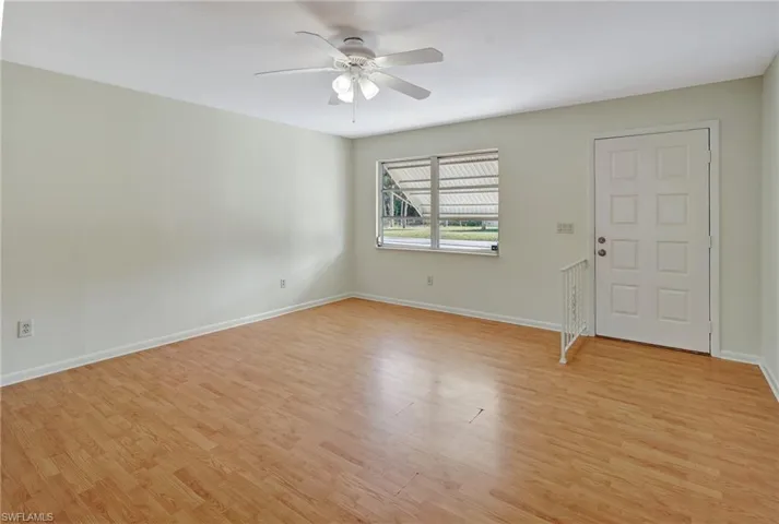 Empty room with light hardwood / wood-style floors and ceiling fan