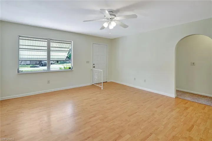 Empty room with light hardwood / wood-style floors and ceiling fan