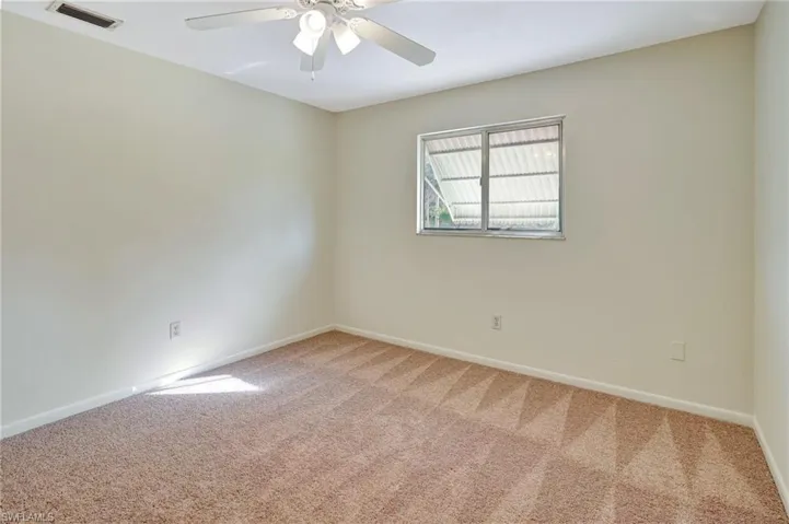 Spare room with carpet floors and ceiling fan