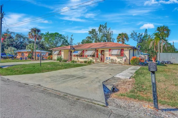Single story home featuring a front lawn