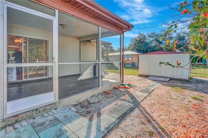 View of patio / terrace with a sunroom and a storage shed