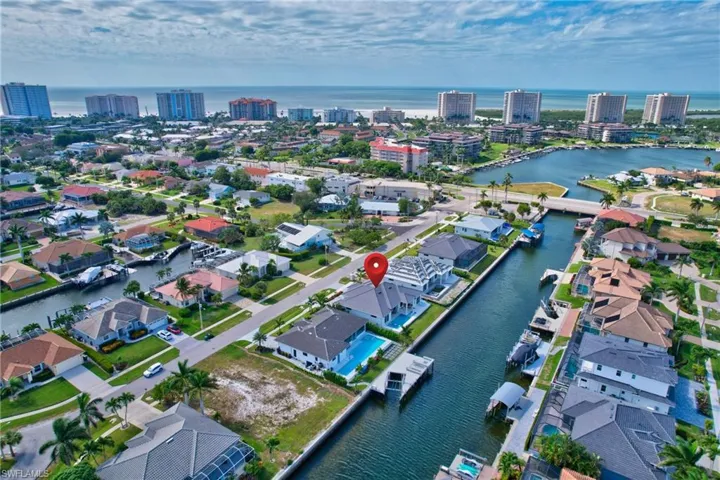 Waterfront property featuring a private boat dock, backyard swimming pool, and direct canal access