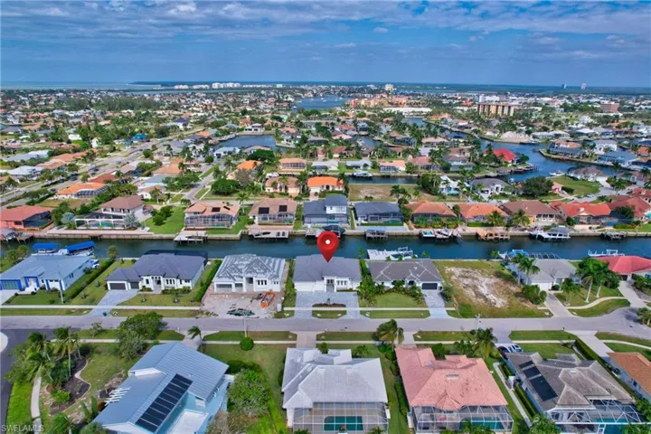 Waterfront property featuring a private boat dock, concrete seawall, and direct access to canals