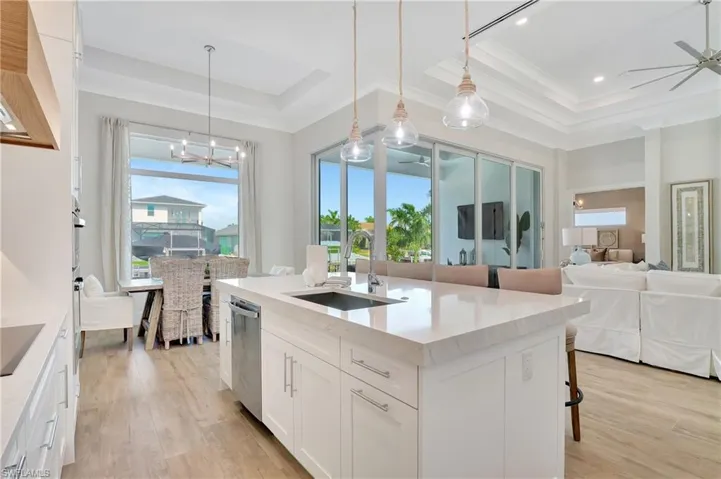 Kitchen island featuring a built-in sink and stainless steel dishwasher
