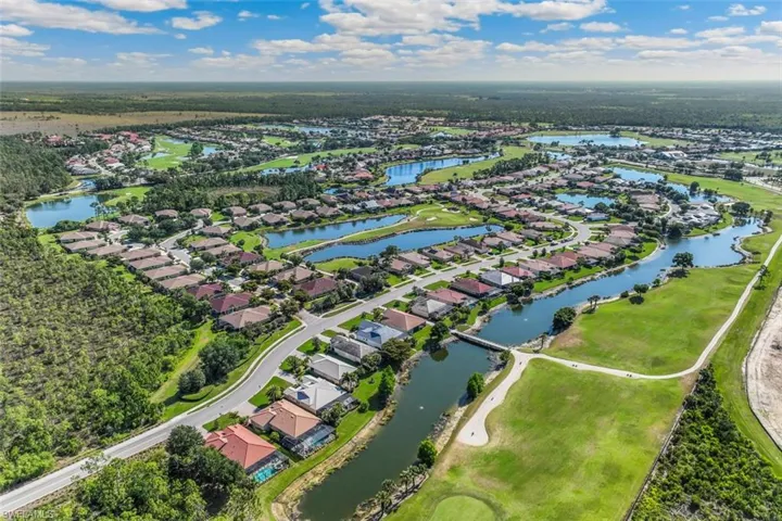 Aerial view of residential area featuring a nearby body of water
