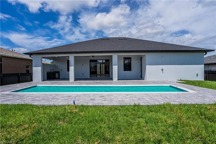 View of pool featuring a patio area, a lawn, and ceiling fan