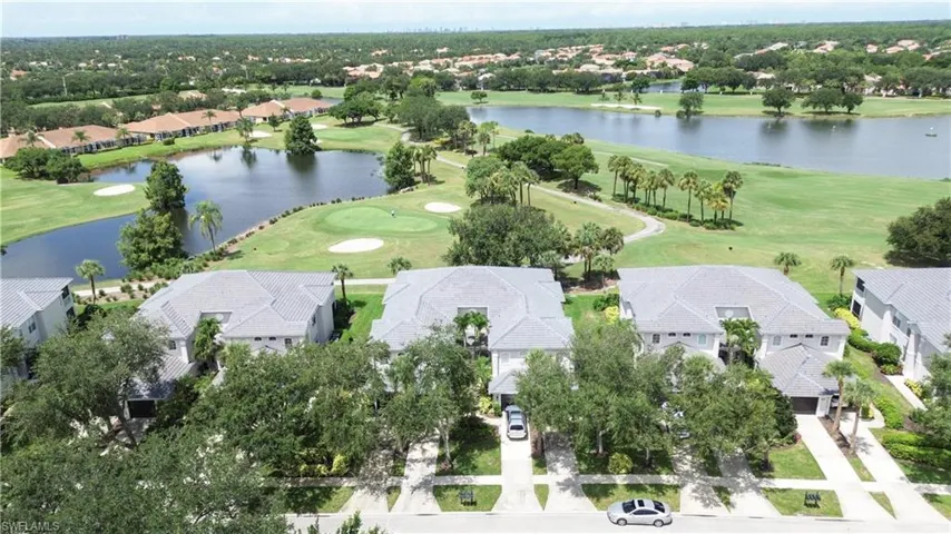 View of property location featuring a golf club and nearby suburban area