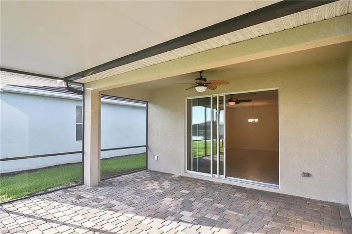 Unfurnished sunroom with ceiling fan