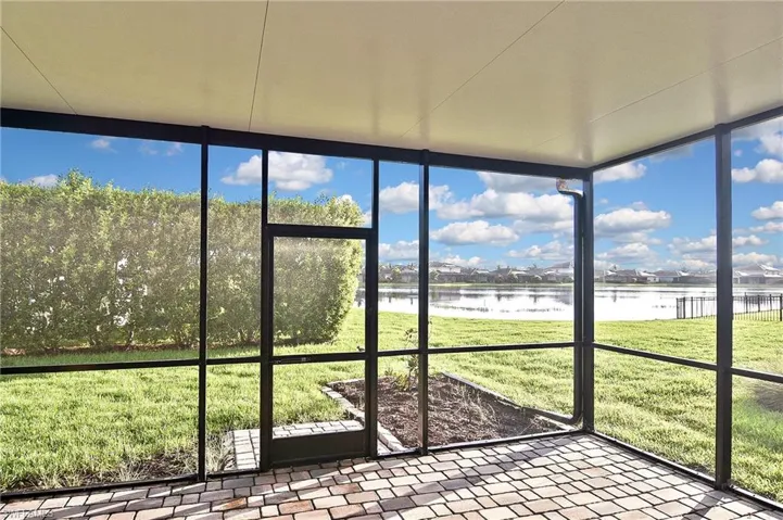Unfurnished sunroom with a wealth of natural light and a water view