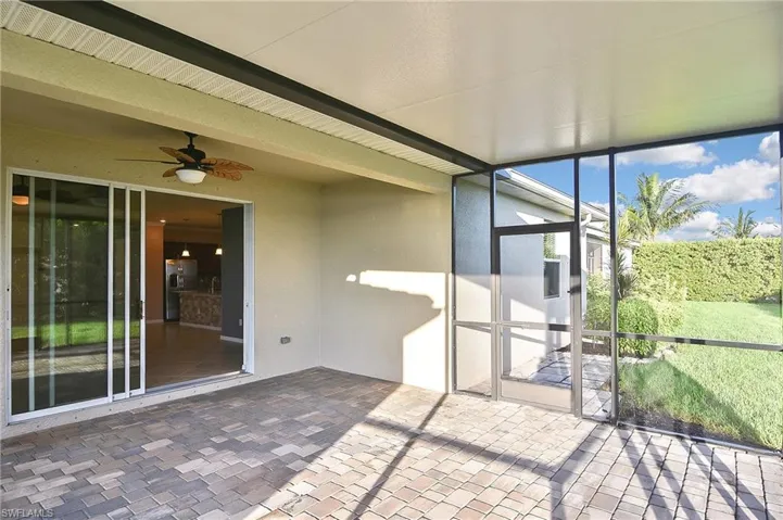 Unfurnished sunroom featuring ceiling fan
