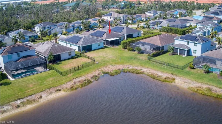 Birds eye view of property with a water view