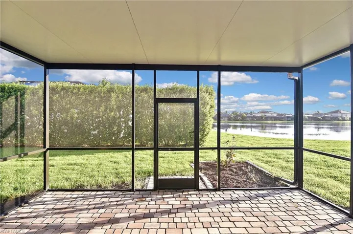 Unfurnished sunroom featuring a water view