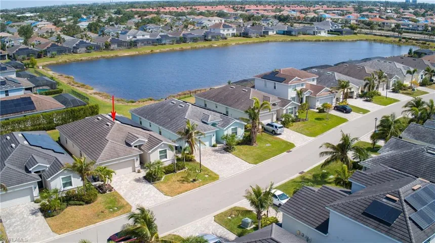 Birds eye view of property with a water view