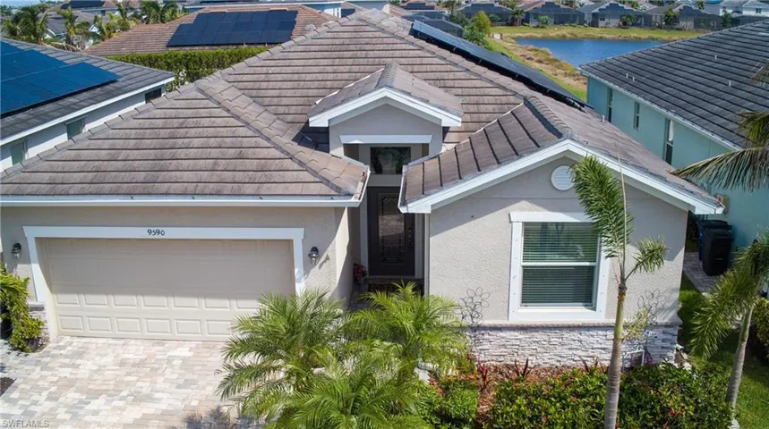 View of front of home featuring a garage and solar panels