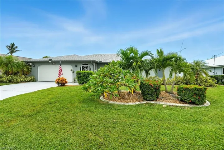 Ranch-style home featuring stucco siding, driveway, a front lawn, and an attached garage