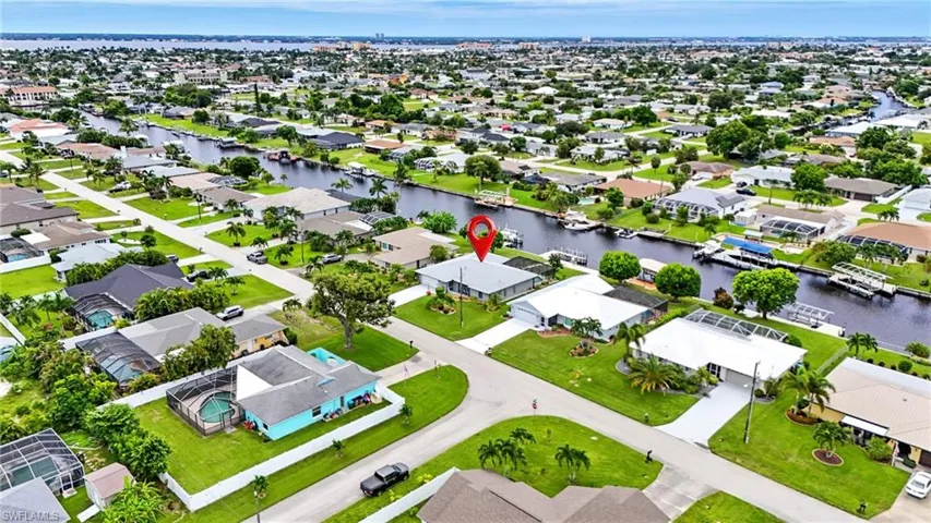 Aerial perspective of suburban area featuring a large body of water