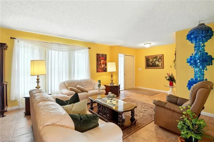 Living area featuring tile patterned flooring and a textured ceiling