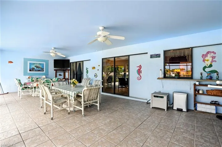 Dining space with ceiling fan and light tile patterned floors