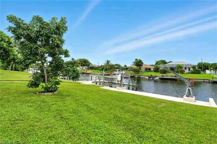 Dock area featuring a yard, a water view, and boat lift