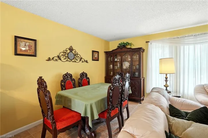 Tiled dining area with a textured ceiling