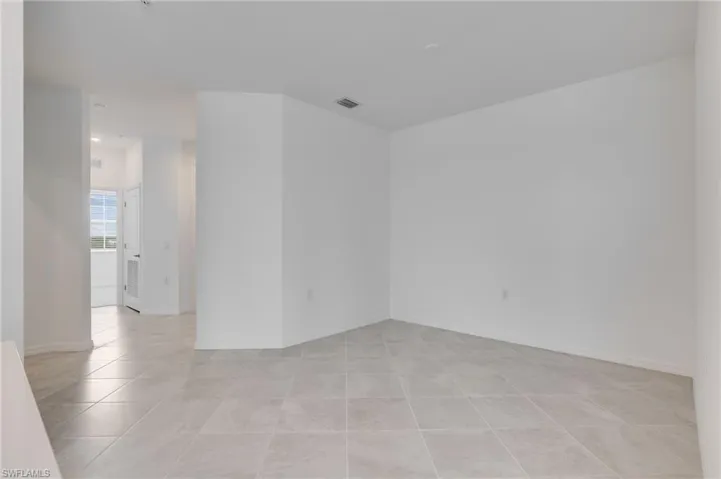 Spare room featuring baseboards and light tile patterned floors